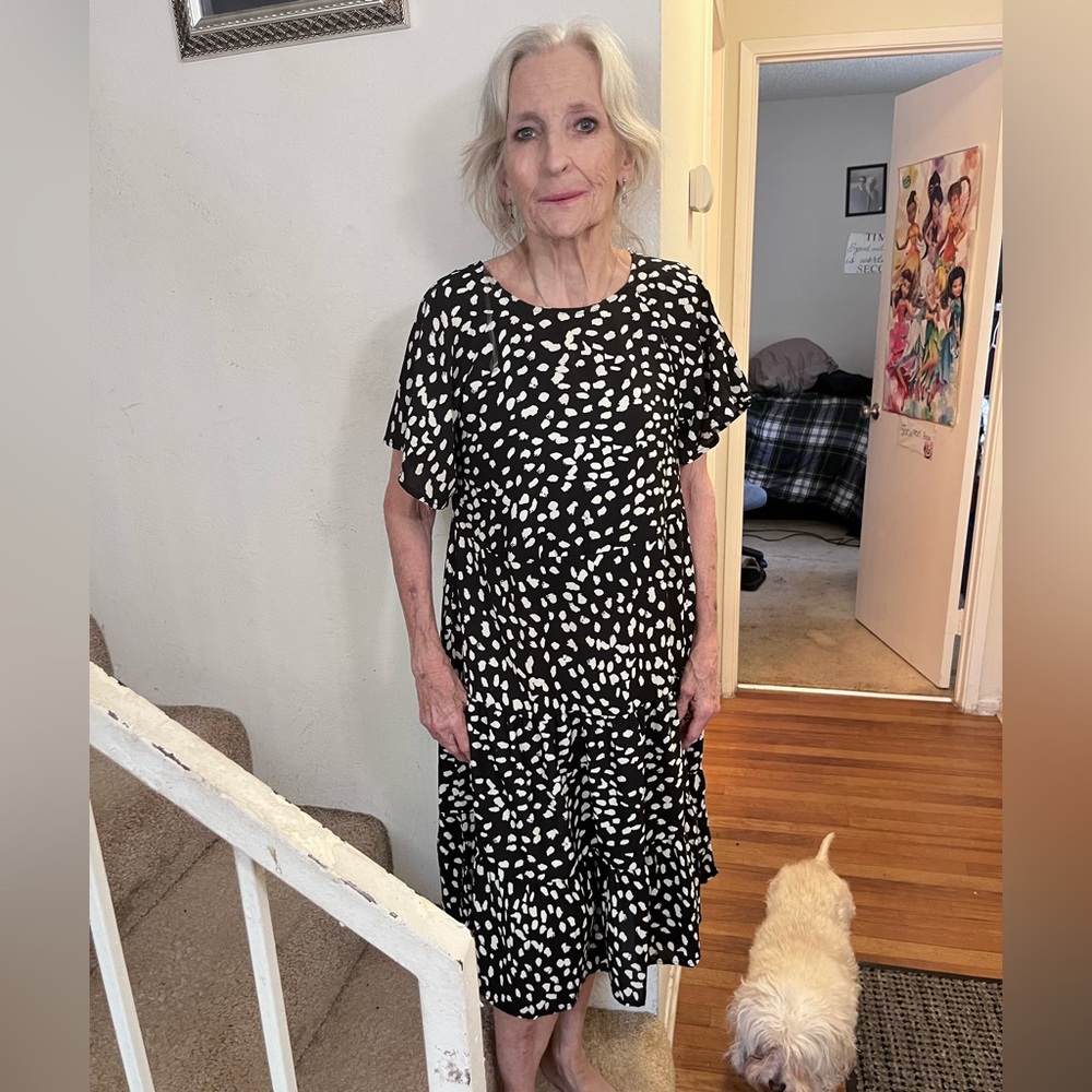 Women’s knee length dress, spots (white) on either black or dark blue.